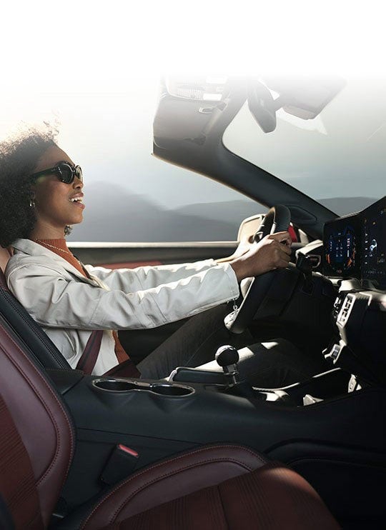 Person sitting in the driver’s seat of a 2024 Ford Mustang® convertible | White Ford Lincoln, L.L.C. in Winnsboro LA